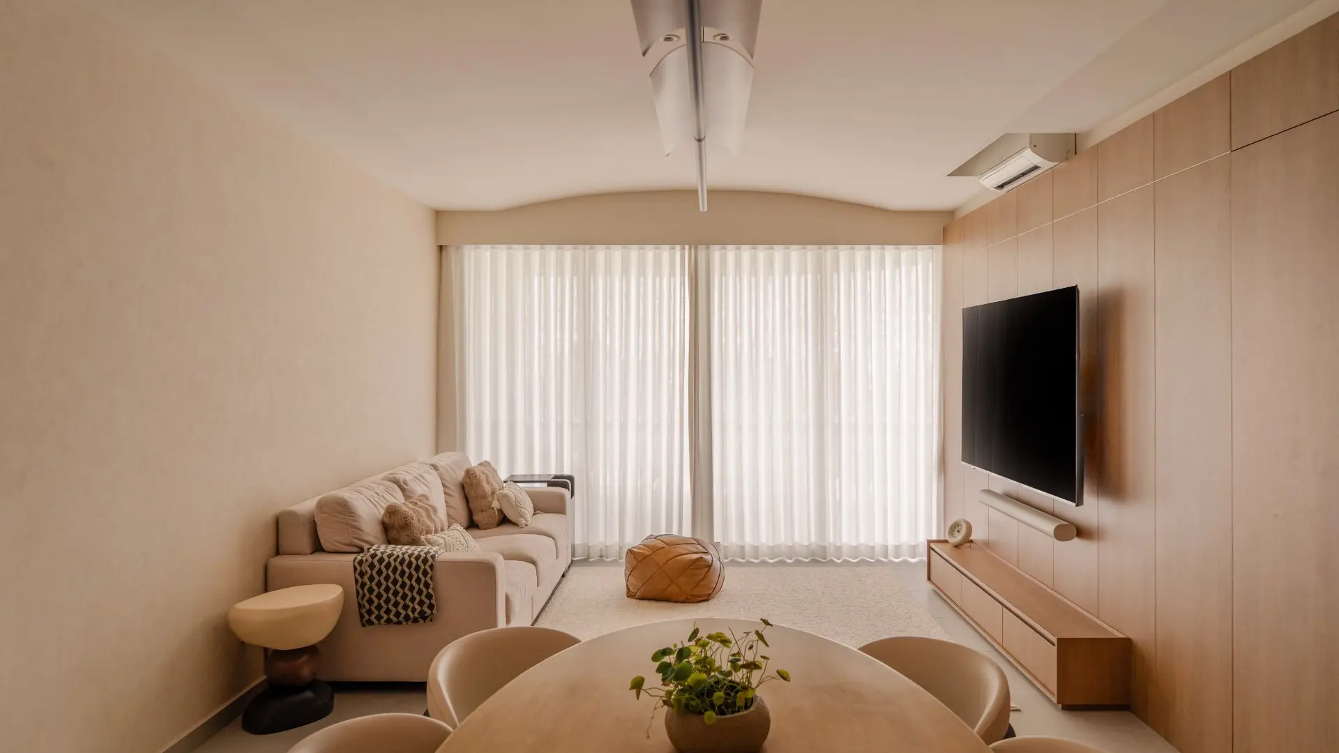 Warm neutral-toned living and dining area in renovated HDB flat by 6AM Spaces
